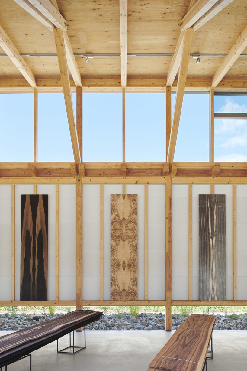 ninkipen! completes gallery for veneer company with deep overhangs in yao, japan