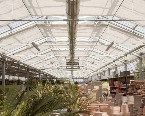 studio bressan's 'green village' garden center expresses solid and transparent volumes