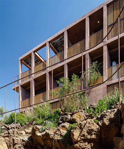 terracotta-colored concrete volumes + wooden lattice frames complete hotel in mexico