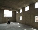 torafu architects completes residential building in tokyo with high-ceiling concrete interiors