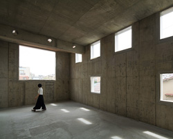 torafu architects completes rental building in tokyo with high-ceiling concrete interiors