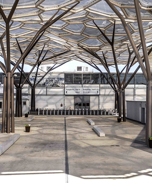 tree-shaped steel columns + organic undulating roof shelter trade show facilities in italy