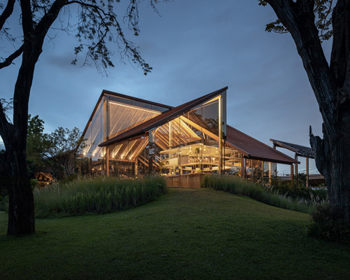 transparent volume of NITAPROW's patom cafe in thailand reveals expressive, folding roof