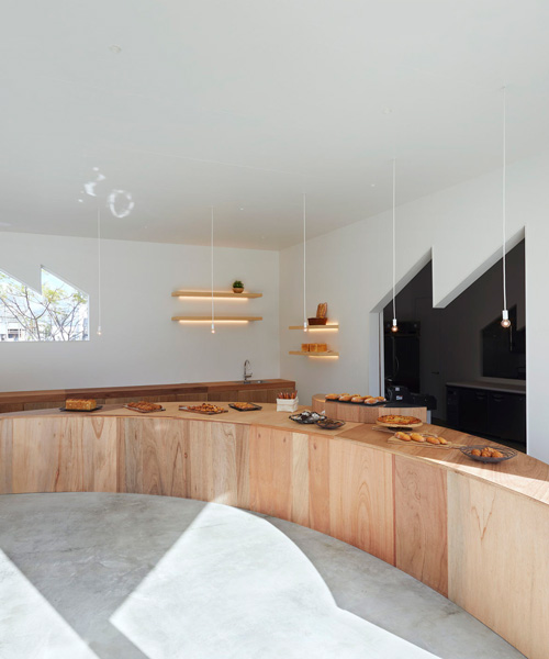 airhouse completes 'bakery tsukiakari' in japan with half-moon wooden counter 