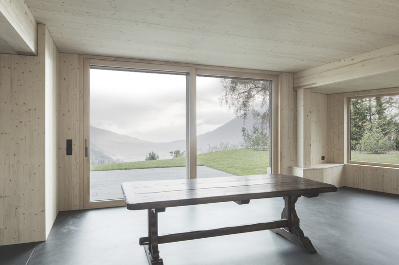 atelier risi combines tree bark + concrete for the exterior of this house in böschi, switzerland