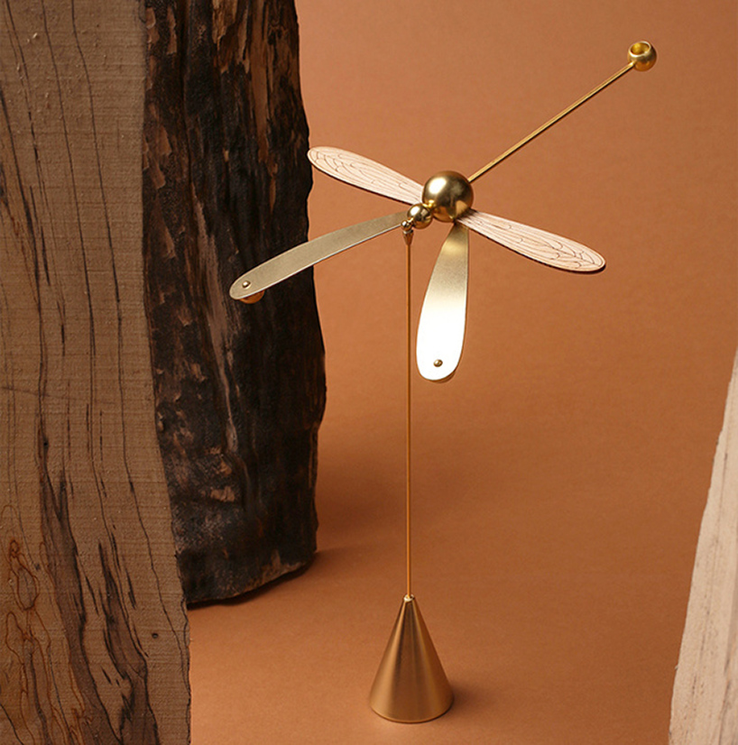 this dragonfly diffuser set balances on its beak while spreading gentle aromas
