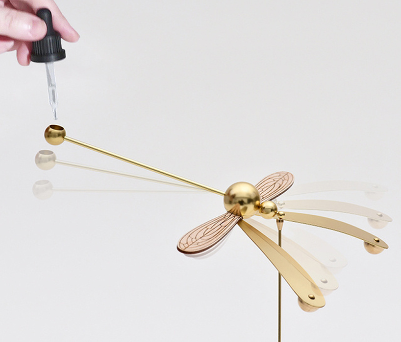 this dragonfly diffuser set balances on its beak while spreading gentle aromas