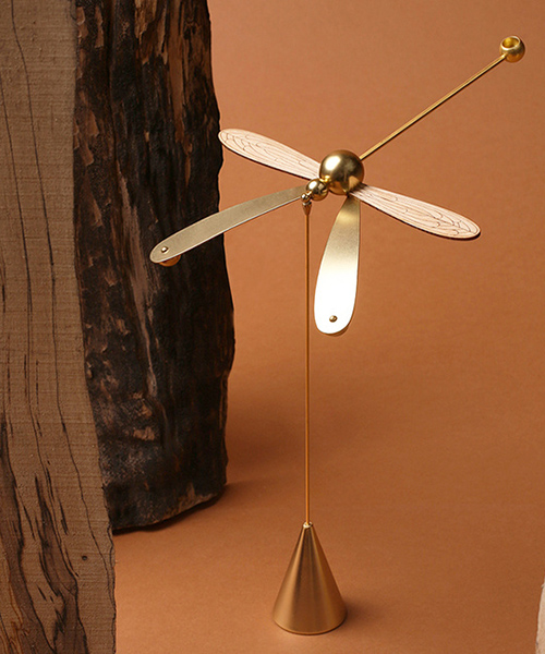 this dragonfly diffuser set balances on its beak while spreading gentle aromas