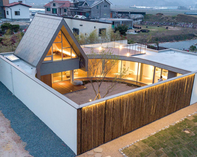 formative architects articulates 'walden house' in south korea around a walled courtyard