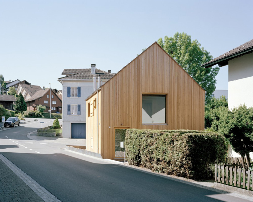 lukas lenherr transforms storage building into small timber house in switzerland