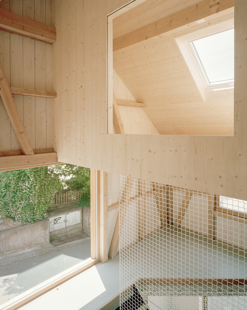 lukas lenherr transforms storage building into small timber house in switzerland