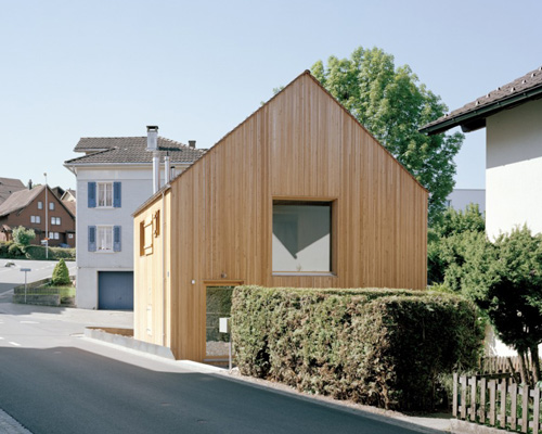 lukas lenherr transforms storage building into small timber house in switzerland