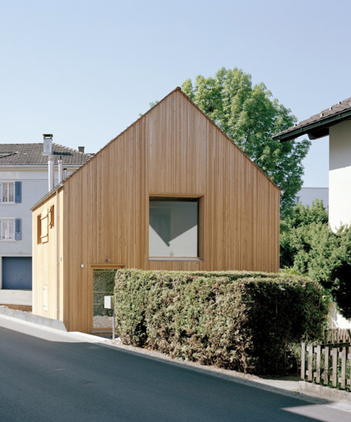 lukas lenherr transforms storage building into small timber house in switzerland