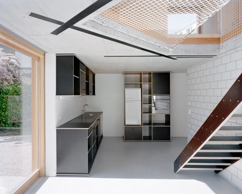 lukas lenherr transforms storage building into small timber house in switzerland