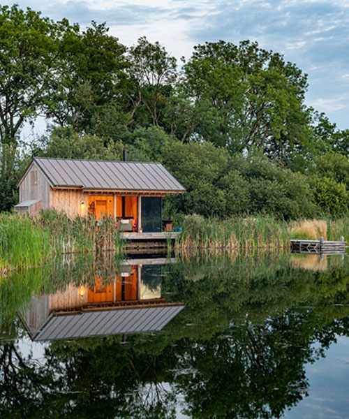 oak wood cladding + concrete details build lake cabin by RX architects in the UK