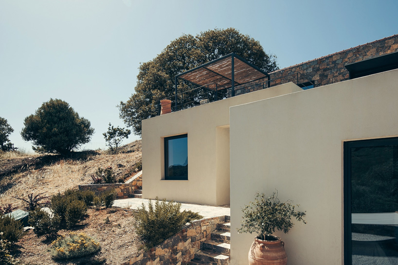 polyergo's summer house sits on a steep slope on the island of crete, greece