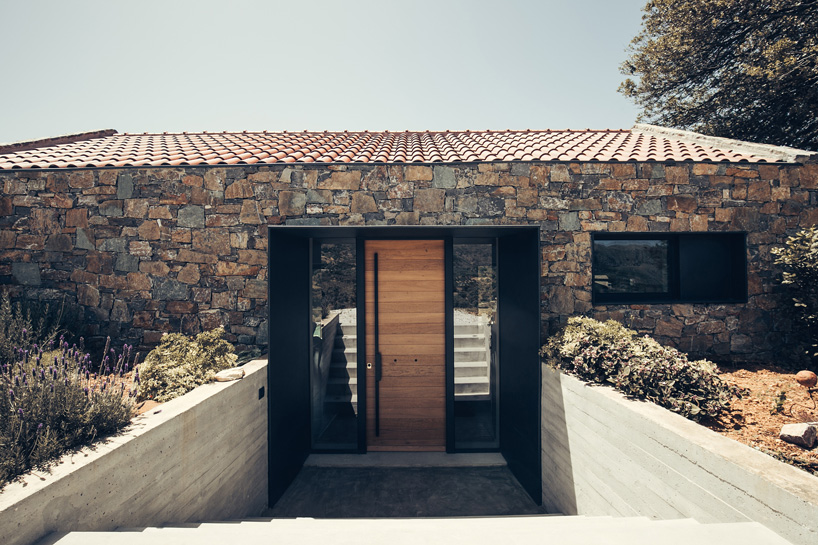polyergo's summer house sits on a steep slope on the island of crete, greece