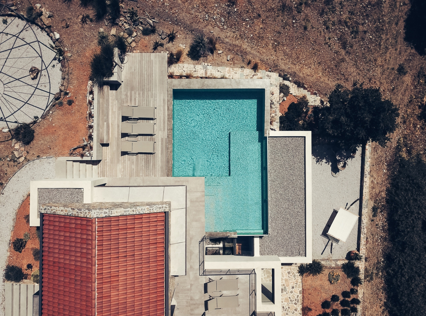 polyergo's summer house sits on a steep slope on the island of crete, greece