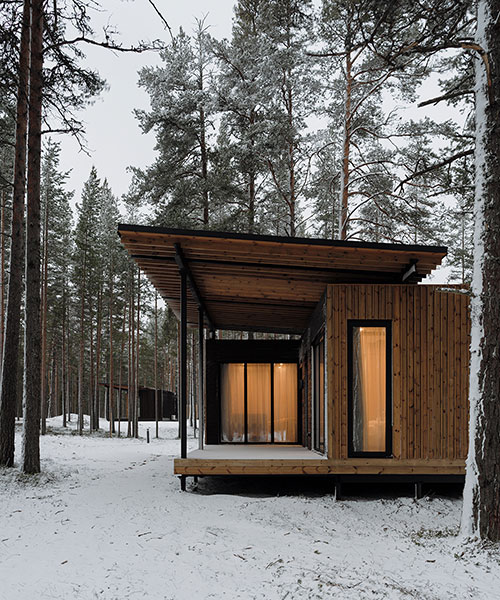 prefab cabin hotel by rhizome settles isolated within karelian landscape, in russia