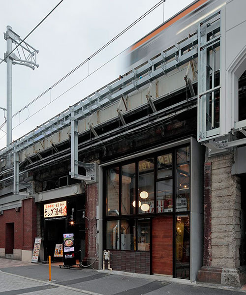steel H-beams build coffee shop situated under railway elevated bridge in tokyo