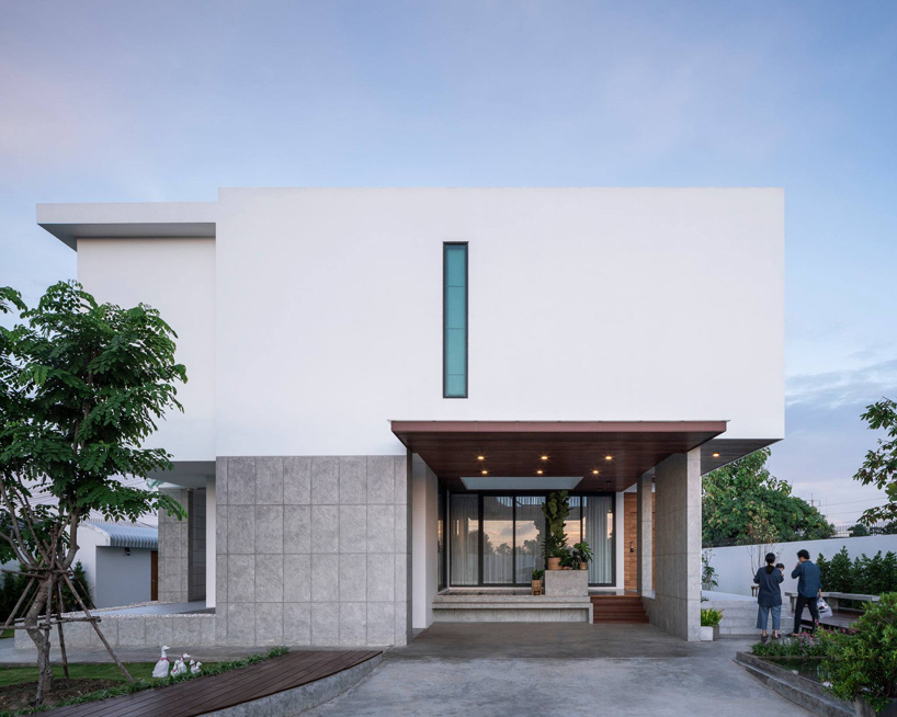 TOUCH architect inserts glass voids for growing trees in the 'stack-cube' house in thailand