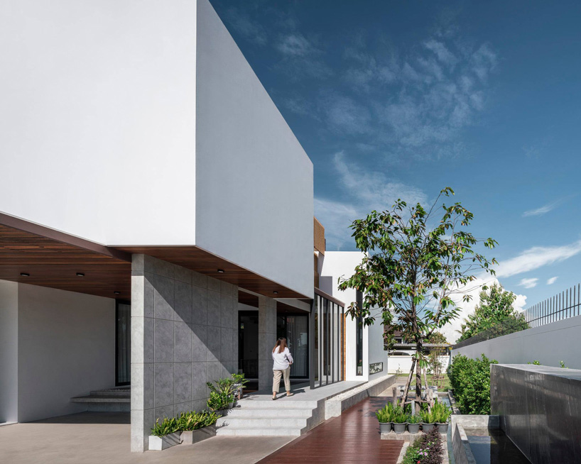 TOUCH architect inserts glass voids for growing trees in the 'stack-cube' house in thailand