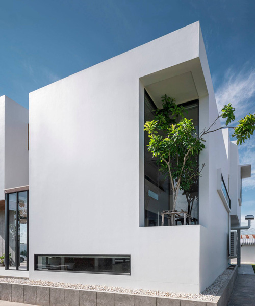 TOUCH architect inserts glass voids for growing trees in the 'stack-cube' house in thailand