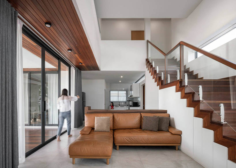TOUCH architect inserts glass voids for growing trees in the 'stack-cube' house in thailand