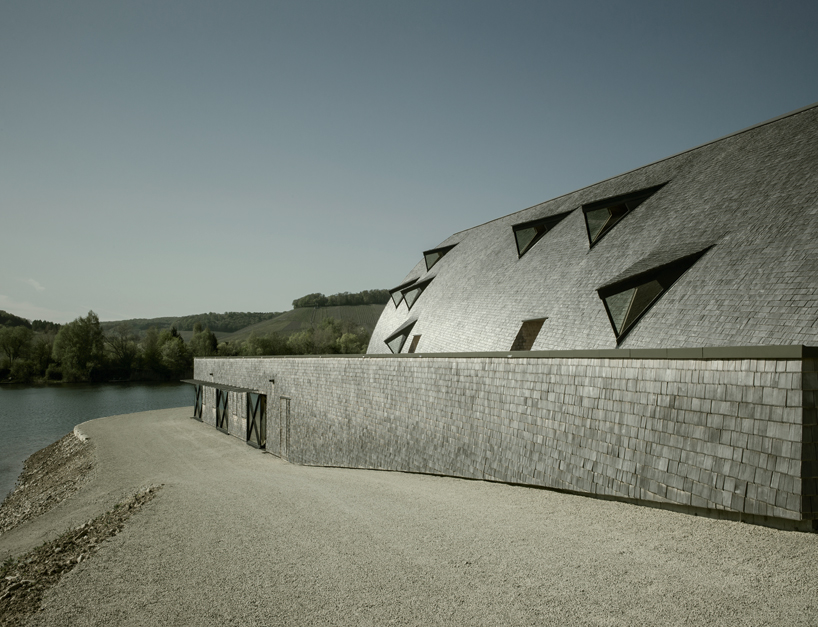 longhouse-inspired 'biodiversum' visitor center blends into a nature reserve in luxembourg