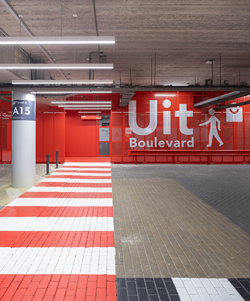 XML uses bright red accents to facilitate orientation within parking garage in amsterdam