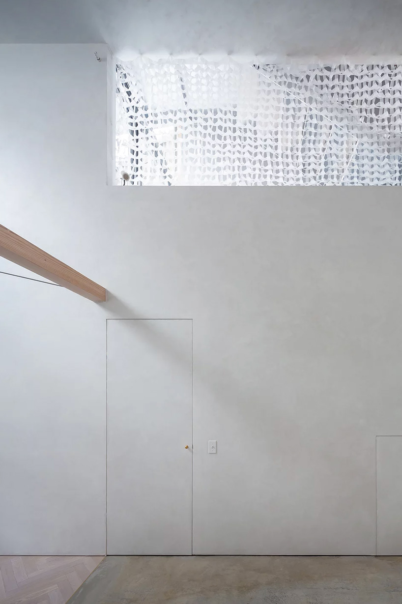 atelierco architects splits 'brass house' in tokyo in two symmetrical halves