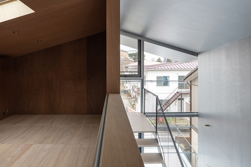 atelierco architects splits 'brass house' in tokyo in two symmetrical ...