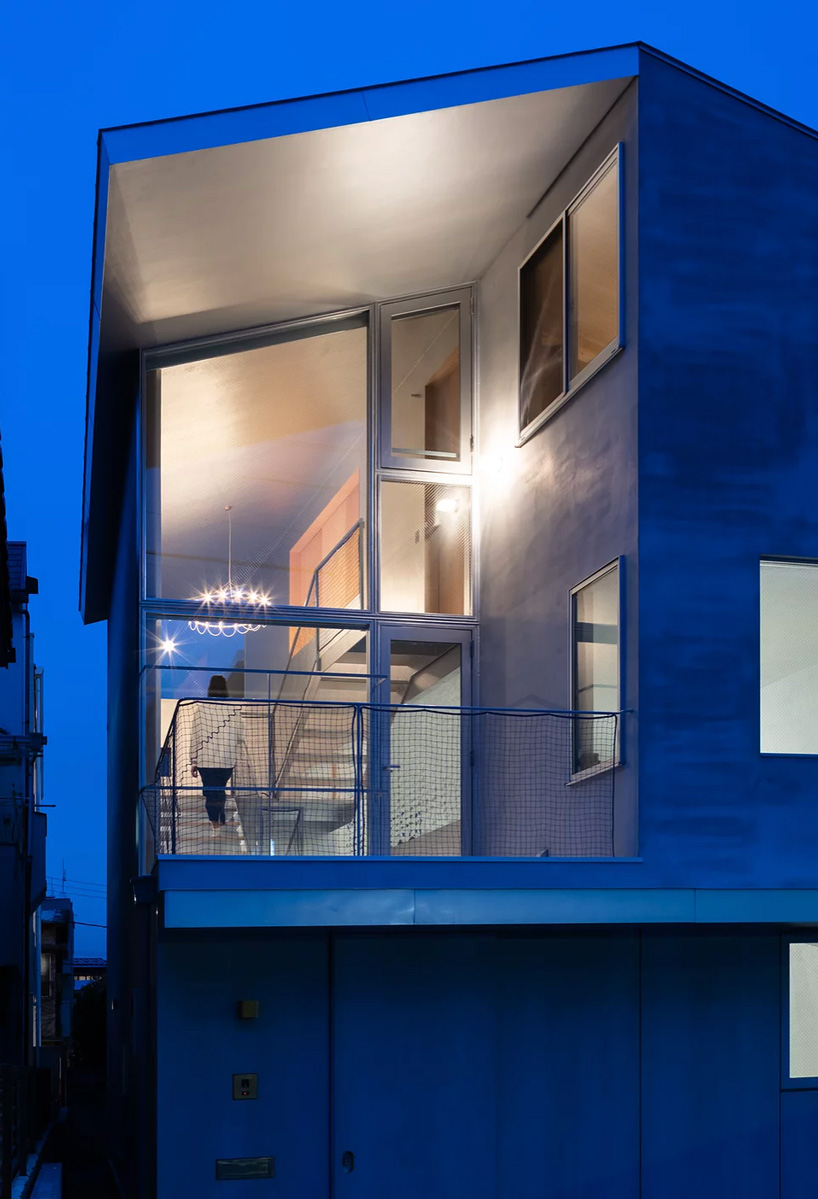 atelierco architects splits 'brass house' in tokyo in two symmetrical halves