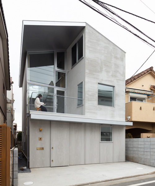 atelierco architects splits 'brass house' in tokyo in two symmetrical halves