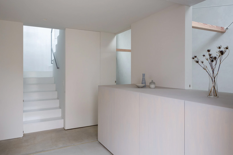 atelierco architects splits 'brass house' in tokyo in two symmetrical halves