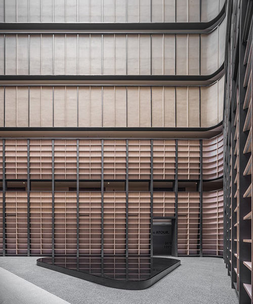 BEHIVE architects designs shanghai hotel around a 7 storey triangular atrium