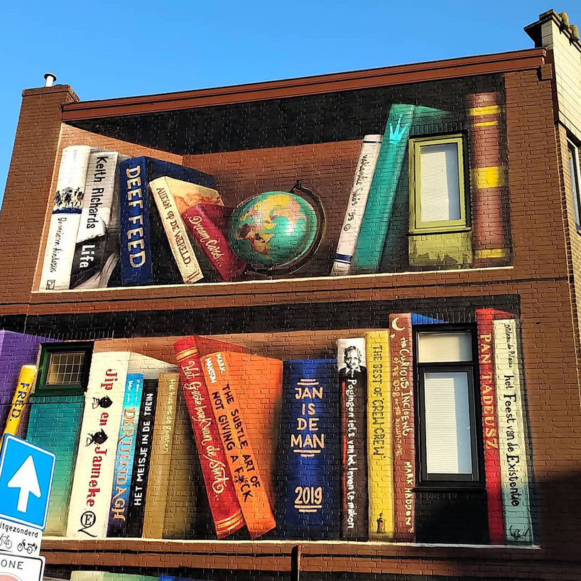 dutch street artist paints a massive bookcase on a three-level building in utrecht