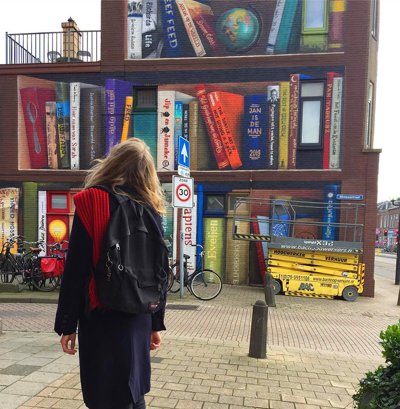 dutch street artist paints a massive bookcase on a three-level building in utrecht