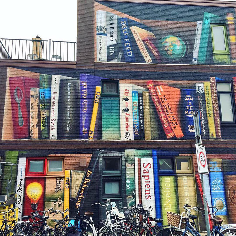 dutch street artist paints a massive bookcase on a three-level building in utrecht