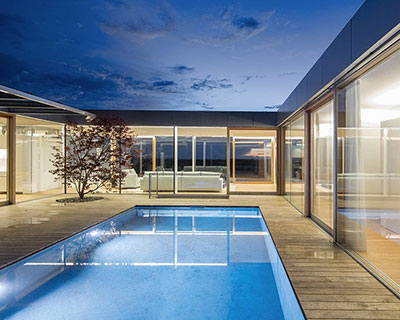 christian tonko's residence in austria wraps around central courtyard with swimming pool