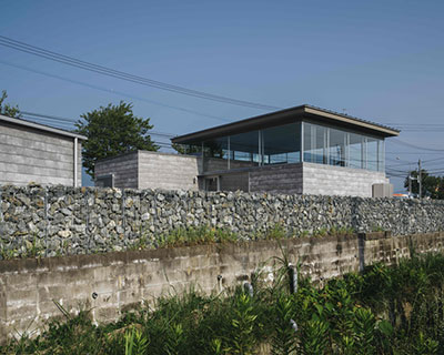 concrete, steel & broken stones form family residence by peak studio in iizuka, japan