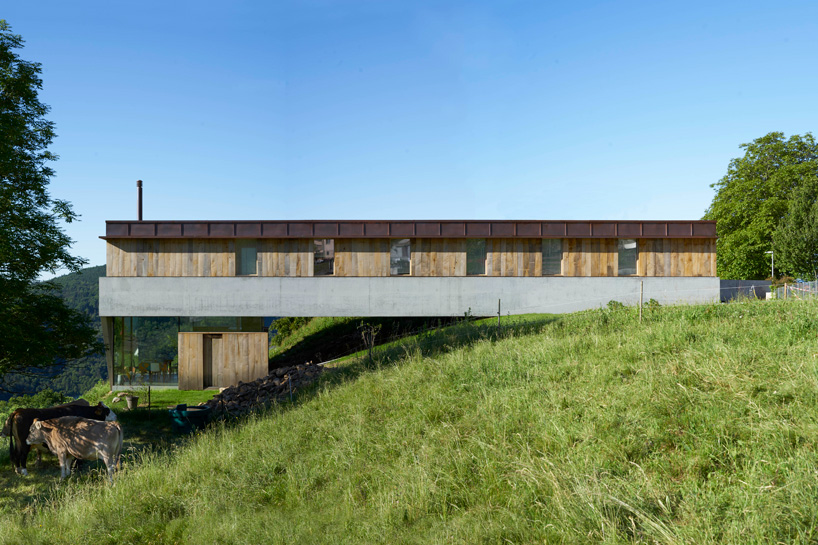 federico rella's concrete + timber house overlooks the mountainous landscape of lugano