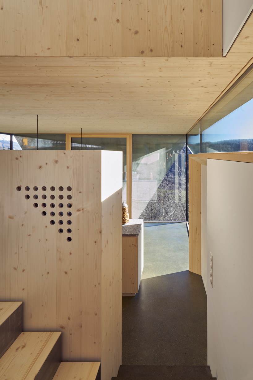 federico rella's concrete + timber house overlooks the mountainous landscape of lugano