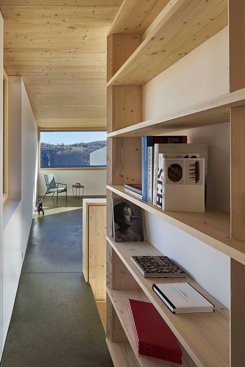 federico rella's concrete + timber house overlooks the mountainous landscape of lugano
