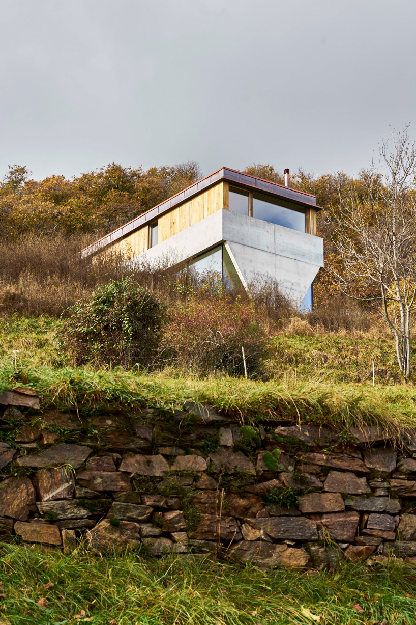 federico rella's concrete + timber house overlooks the mountainous landscape of lugano