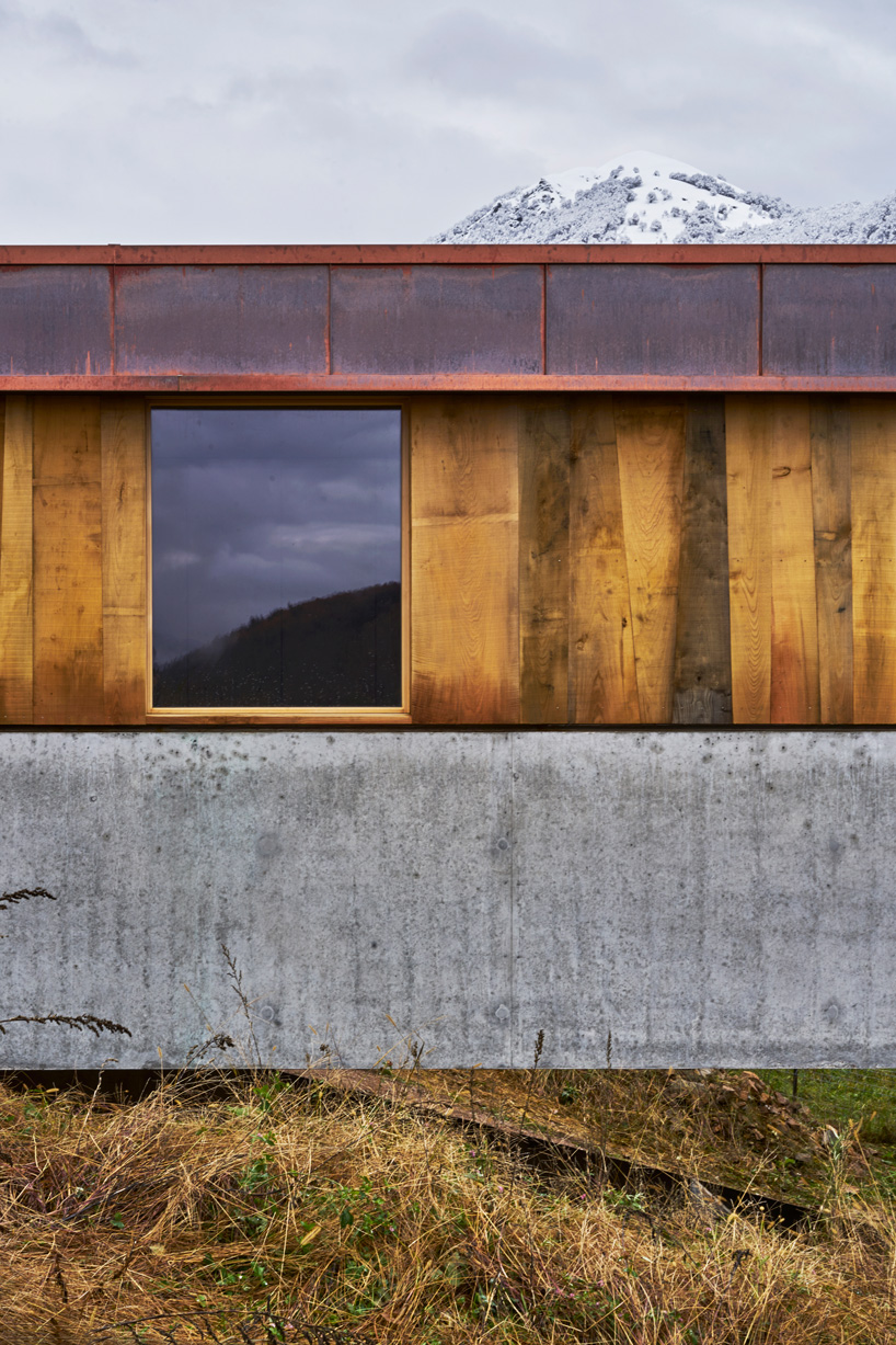 federico rella's concrete + timber house overlooks the mountainous landscape of lugano