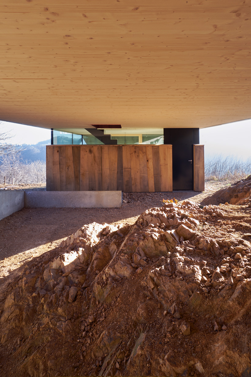 federico rella's concrete + timber house overlooks the mountainous landscape of lugano