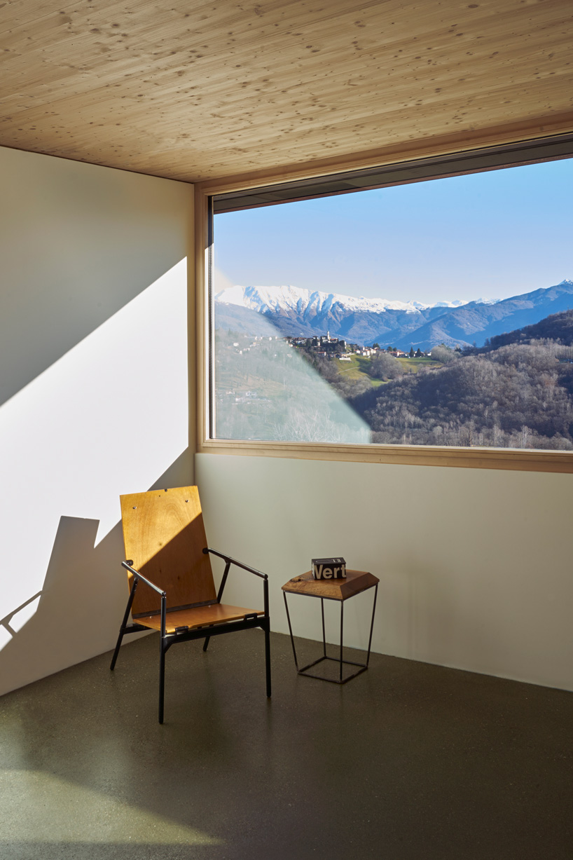 federico rella's concrete + timber house overlooks the mountainous landscape of lugano