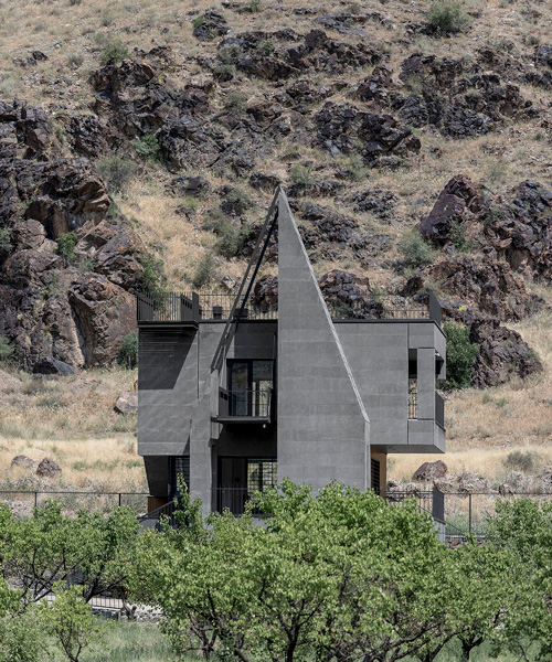 'gray villa' by white cube atelier draws from iran's irregular rocks + mountains