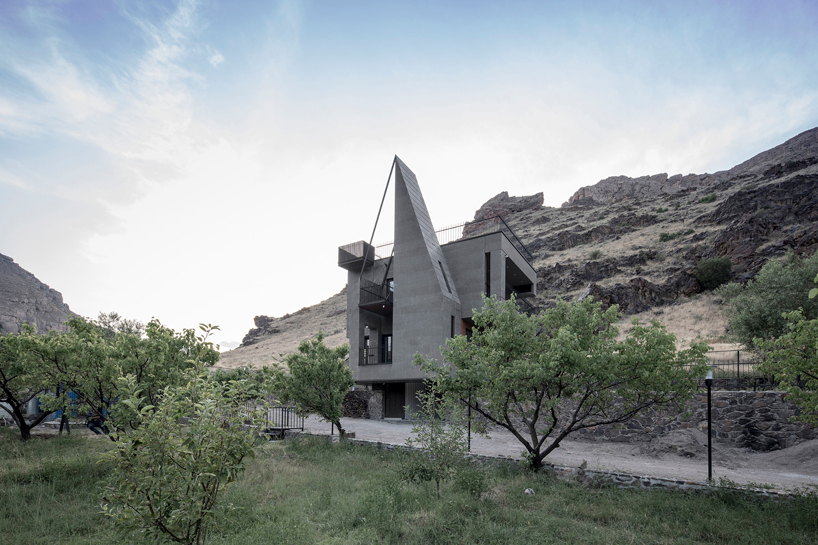 'gray villa' by white cube atelier draws from iran's irregular rocks + mountains